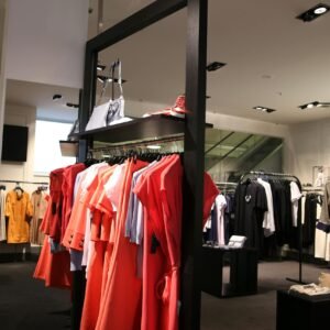Discover a chic fashion boutique showcasing a variety of colorful clothes on elegant racks.